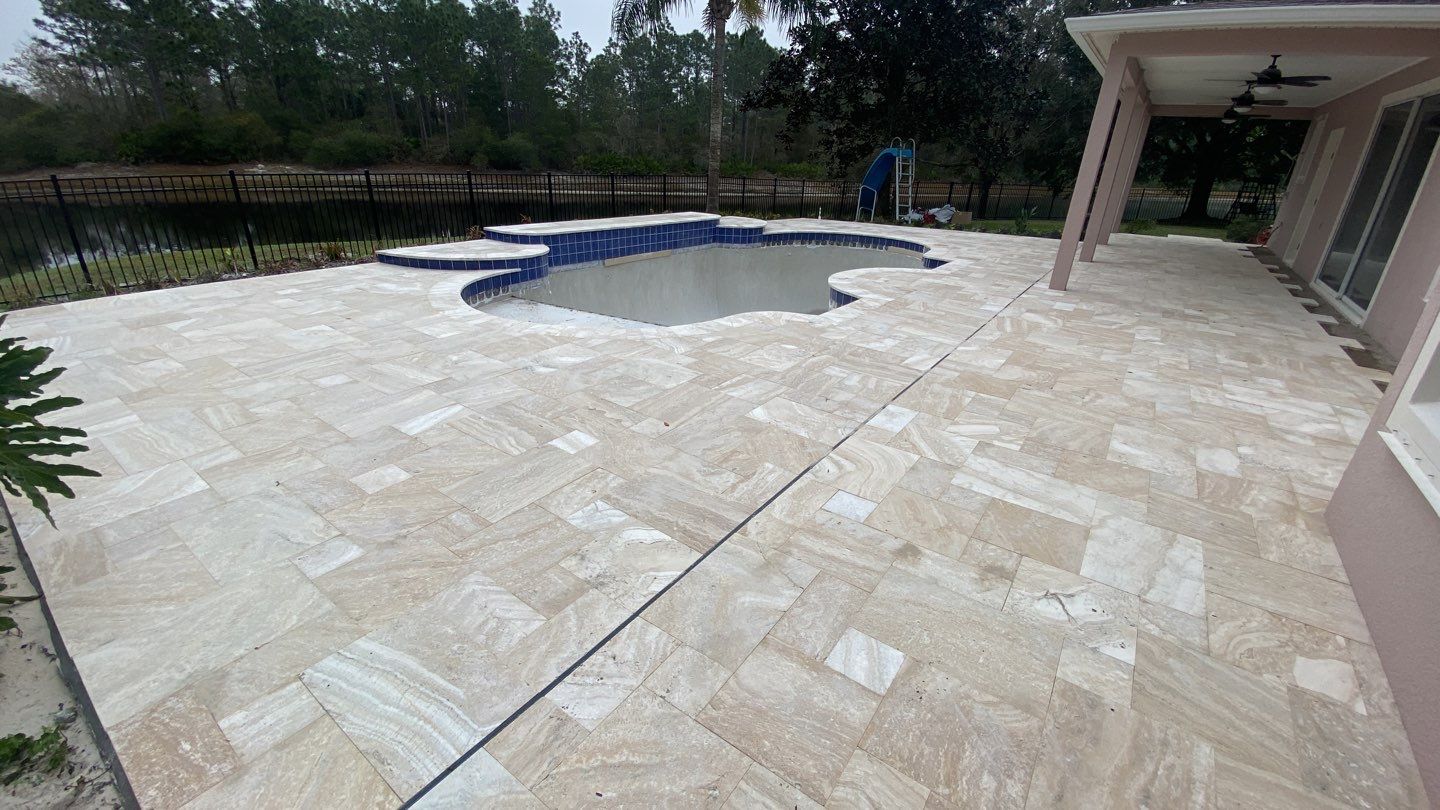 Marble pavers installed in aboriginal travertine pool deck